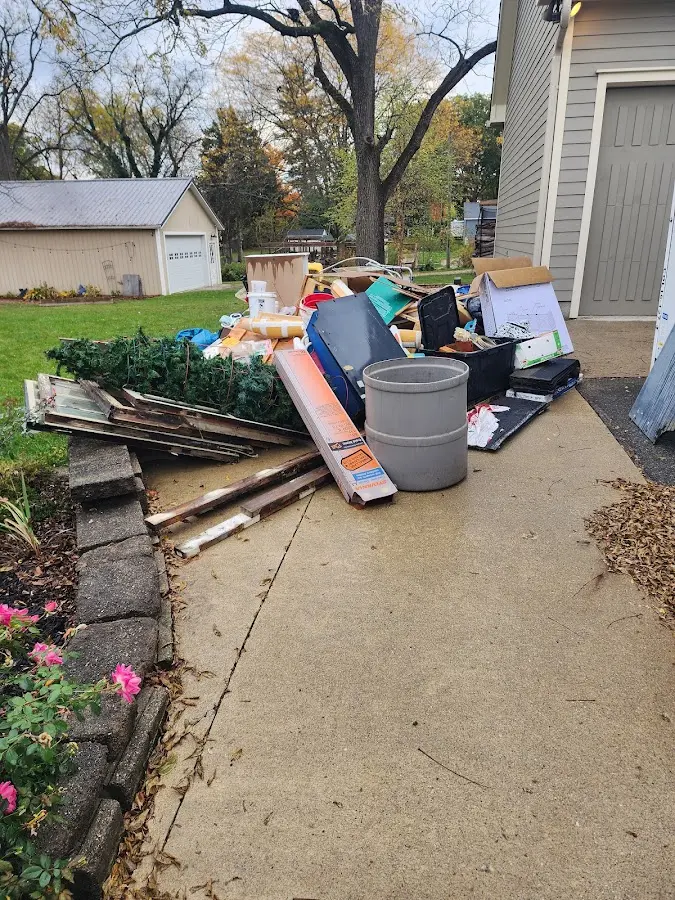Dumpster being loaded with debris for Commercial Dumpster Rental in Keokuk